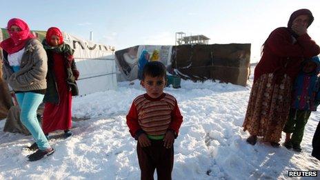 A child refugee from the northern province of Raqqa in Syria, reacts from the cold weather in a Syrian refugee camp beside the Lebanese border town of Arsal, in eastern Bekaa Valley (December 12)