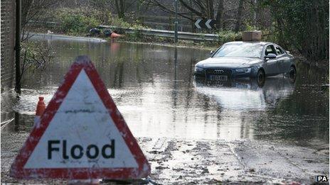 An abandoned Audi car sits in flood water in Chertsey, Surrey