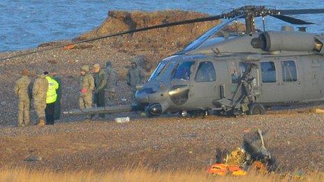 A Pave Hawk helicopter at the scene of a helicopter crash on the coast near the village of Cley next the Sea in Norfolk