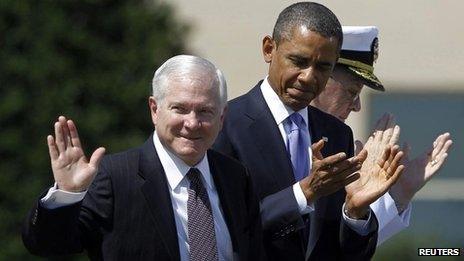 Retiring US Defence Secretary Robert Gates acknowledges applause as he stands next to President Barack Obama in Washington 30 June 2011