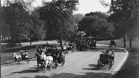 Horse and carriages drive through Central Park
