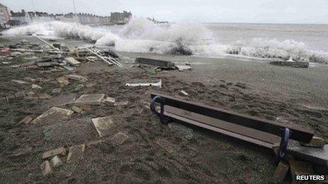 A large wave crashes over the promenade at high tide in Aberystwyth