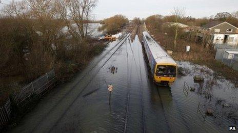 Train travels over flooded tracks in Oxford on Wednesday