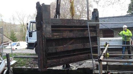 worker replacing a canal lock gate