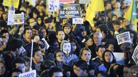 Supporters of Bogota's Mayor Gustavo Petro hold signs reading in Spanish "Petro Stays" during a rally against Colombia's inspector-general Alejandro Ordonez at the main square in Bogota, Colombia, Friday, Jan. 10, 2014.