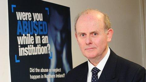 Sir Anthony Hart poses in front of the inquiry's appeal poster