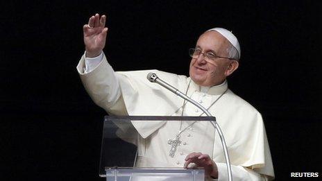 Pope Francis waves as he leads the Angelus prayer from the window of the apostolic palace in St Peter's Square at the Vatican, 12 January