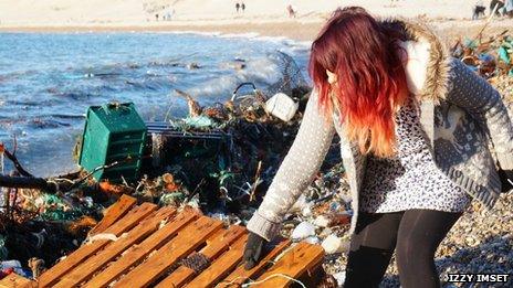 A volunteers collecting rubbish on Chesil Beach