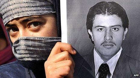 An Afghan girl holds a picture of journalism student Pervez Kambaksh