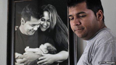 Erick Munoz is seen in front of a photo of his wife, Marlise, in Haltom City, Texas, on 3 January 2014