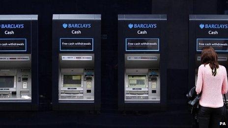 Woman taking money out of a cash point