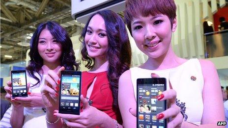 Models holding Huawei's Ascend P6 phone