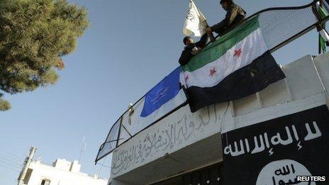 Free Syrian Army fighters erect the Syrian opposition flag