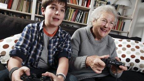 Boy and grandmother playing video game