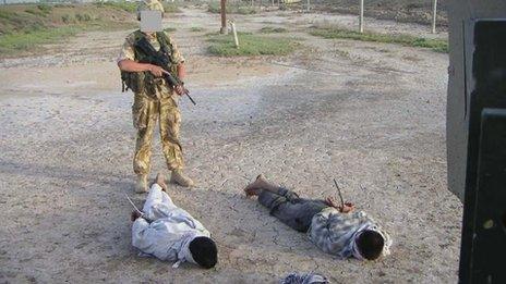 Iraqis being guarded by British soldier