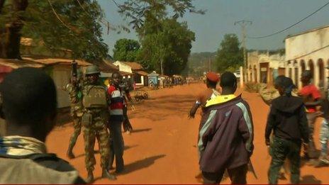 An African Union soldier defends a Muslim man from Christian militiamen