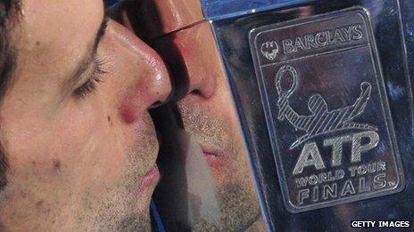 Novak Djokovic kisses the ATP World Tour Finals trophy