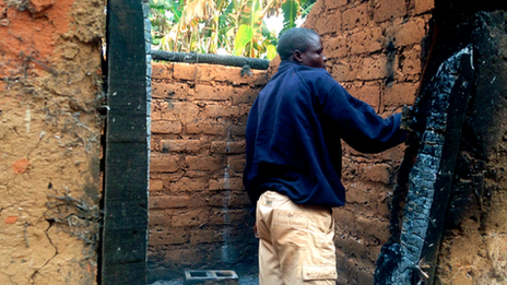 Jerome Ngaina returns to his burnt out house in Bokongo village, Central African Republic