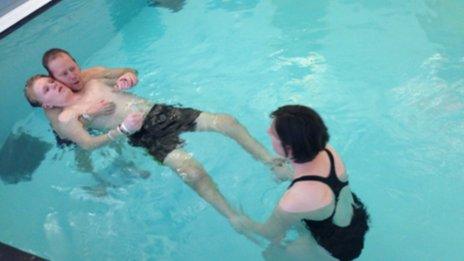 Ryan Smith in the pool with his Dad Mark