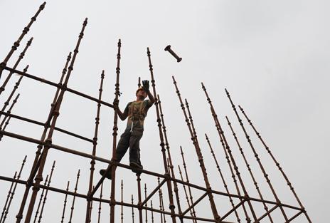 Chinese worker on scaffolding