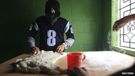 Members of the Barrio 18 knead dough at a bakery in a neighbourhood in Ilopango (September 2013)