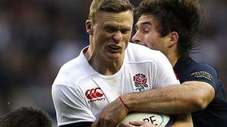 Chris Ashton is tackled playing for England against Argentina