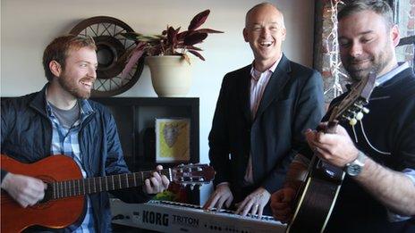 Traylor Woodall (centre) playing music with colleagues