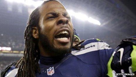 Seattle Seahawks player Richard Sherman celebrates after his team advances to the Super Bowl.