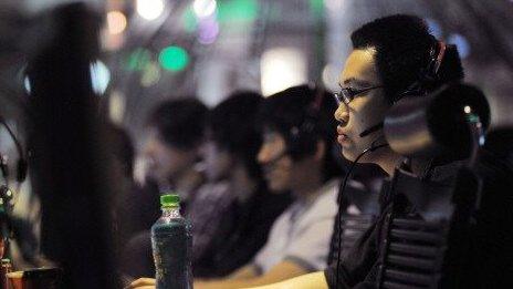 People use computers at an internet cafe in Beijing on May 12, 2011.