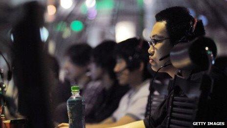 People use computers at an internet cafe in Beijing on May 12, 2011.