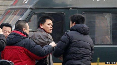 Zhang Xuezhong (centre), a lawyer for Zhao Changqing, outside a Beijing court, 23 January 2014