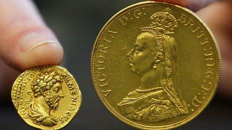 A coin from the reign of Emperor Marcus Aurelius and a £5 Victoria coin