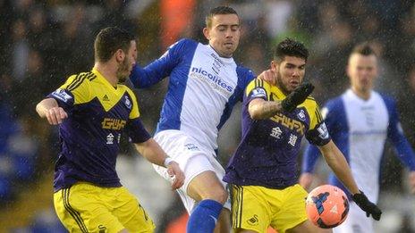 Birmingham's Olly Lee battles for the ball with Swansea's Alejandro Pozuelo