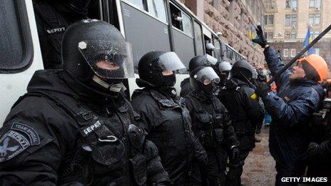 One of the anti-Yanukovych protesters addresses Berkut anti-riot police force officers in Kiev, on December 11, 2013.