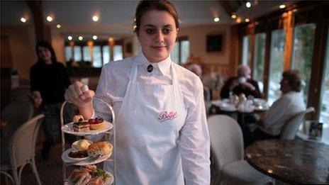 Waitress serving cakes