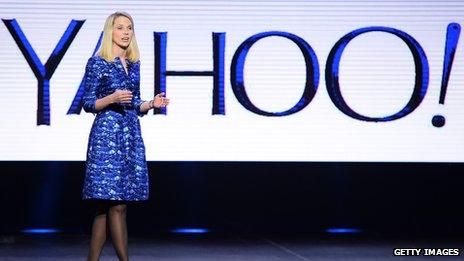 Marissa Meyer in front of Yahoo sign