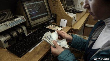 Woman counting lira at an exchange counter