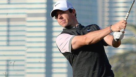 McIlroy watches his shot on the 10th hole on Thursday