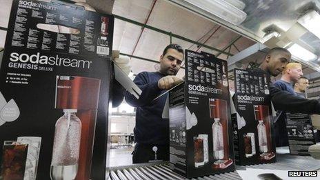 Employees pack boxes of the SodaStream product at the factory in the West Bank Jewish settlement of Maale Adumim on 28 January 2014