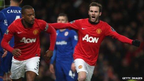 New signing Juan Mata of Manchester United celebrates Robin van Persie scoring against Cardiff