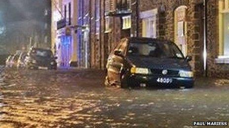 A parked car with water up to its wheels