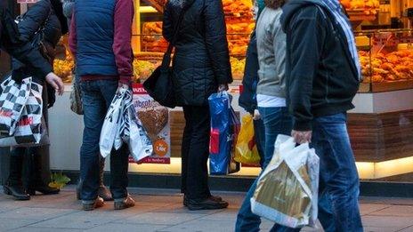 Shoppers pass a bakery in Hamburg