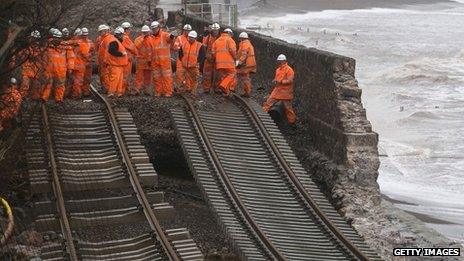 Engineers inspect a section of a mainline rail route swept away in Dawlish, Devon