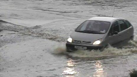 Car driving through flood water in Essex