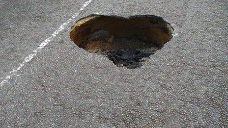 Heart-shaped hole in road