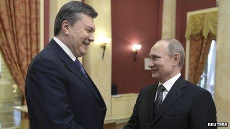 Russia's President Vladimir Putin (R) shakes hands with his Ukrainian counterpart Viktor Yanukovych before a reception to greet foreign guests prior to the 2014 Winter Olympic Games opening ceremony in Sochi, Russia, on Friday