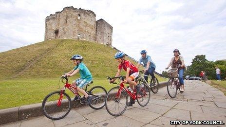 Cyclists at Clifford Tower, York