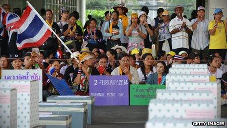 Anti-government protesters in front of ballot boxes at a polling station in Bangkok on 2 February 2014