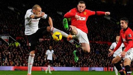 Manchester United forward Wayne Rooney (2L) vies with Fulham's Dutch defender John Heitinga the match between Manchester United and Fulham