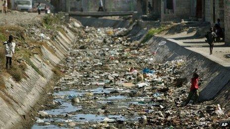 Children playing in an open sewer